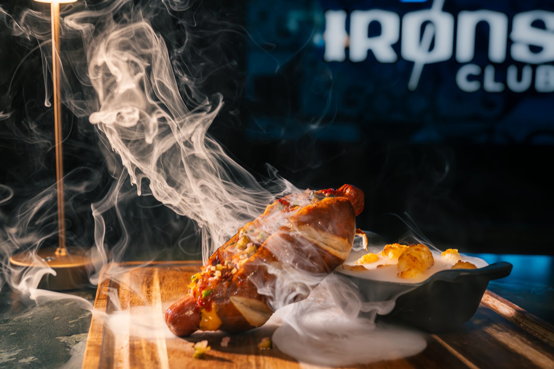 Pepiot Dog gourmet hot dog with smoke effects at The Irons Club