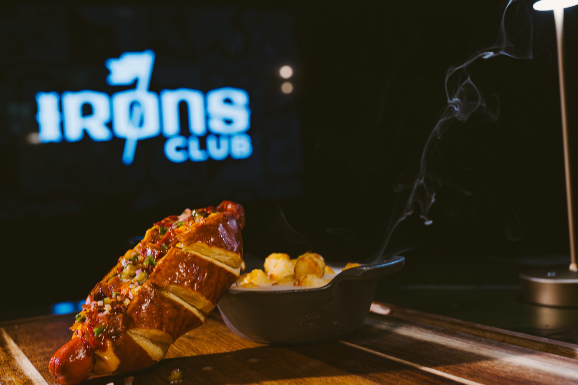 44 Dawg brand shot with Irons Club neon sign